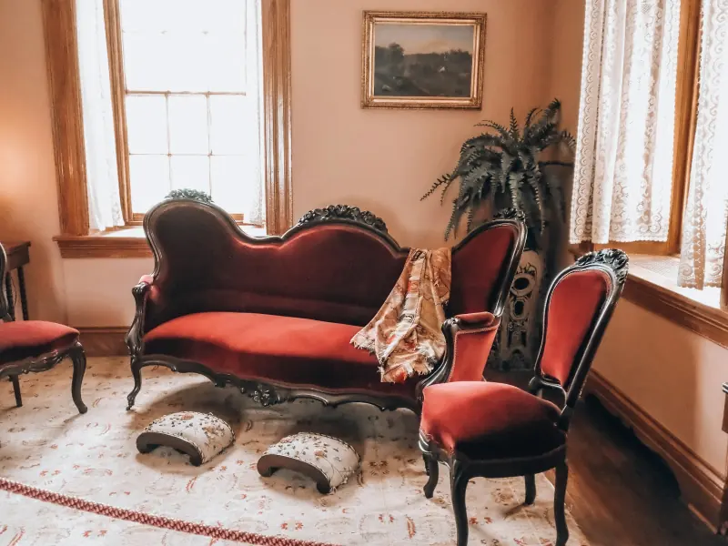 Boudoir aux fauteuils et canapé de velours rouge